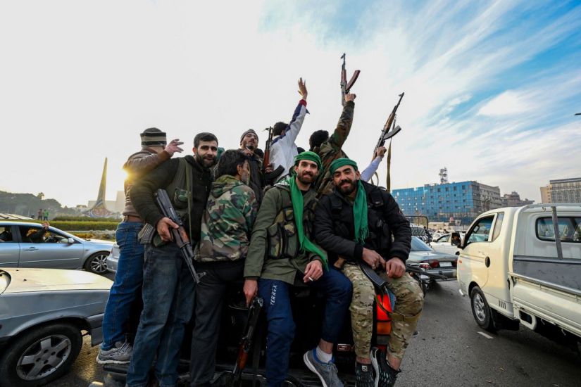 Rebels cheer in Damascus on December 8, 2024. Photo: AFP