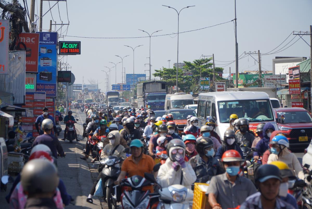 Từ khoảng 10h ngày 18.2, tại Quốc lộ 1 (đoạn qua huyện Bình Chánh) bắt đầu trở nên đông đúc các phương tiện di chuyển hướng từ 13 tỉnh miền Tây về TPHCM. Nhiều thời điểm xảy ra tình trạng ùn ứ nhẹ.