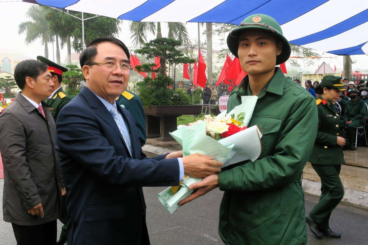 Phó Chủ tịch UBND thành phố Lê Khắc Nam tặng hoa tân binh Vũ Thế Vinh.