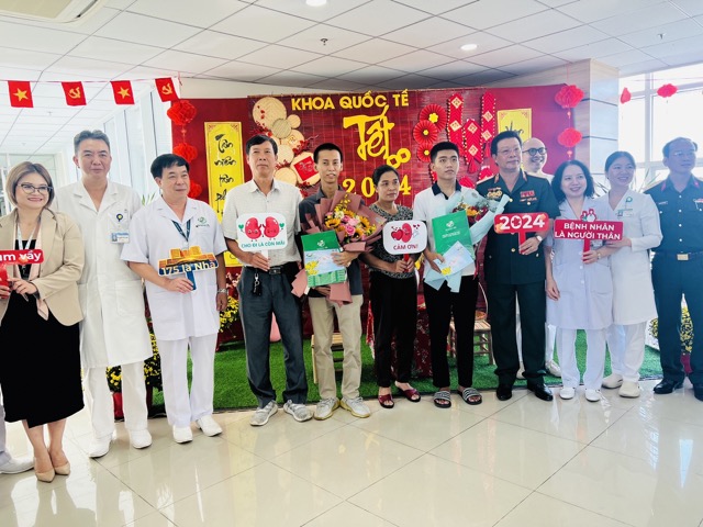 Hai bệnh nhân ghép thận thành công được xuất viện sau 10 ngày (bệnh nhân đứng giữa ôm hoa). Ảnh: NGUYỄN LY 