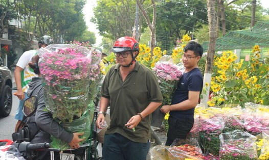 Trưa 30 Tết, nhiều người dân đổ về các chợ hoa để mua hoa chưng Tết. Ảnh: Huân Cao
