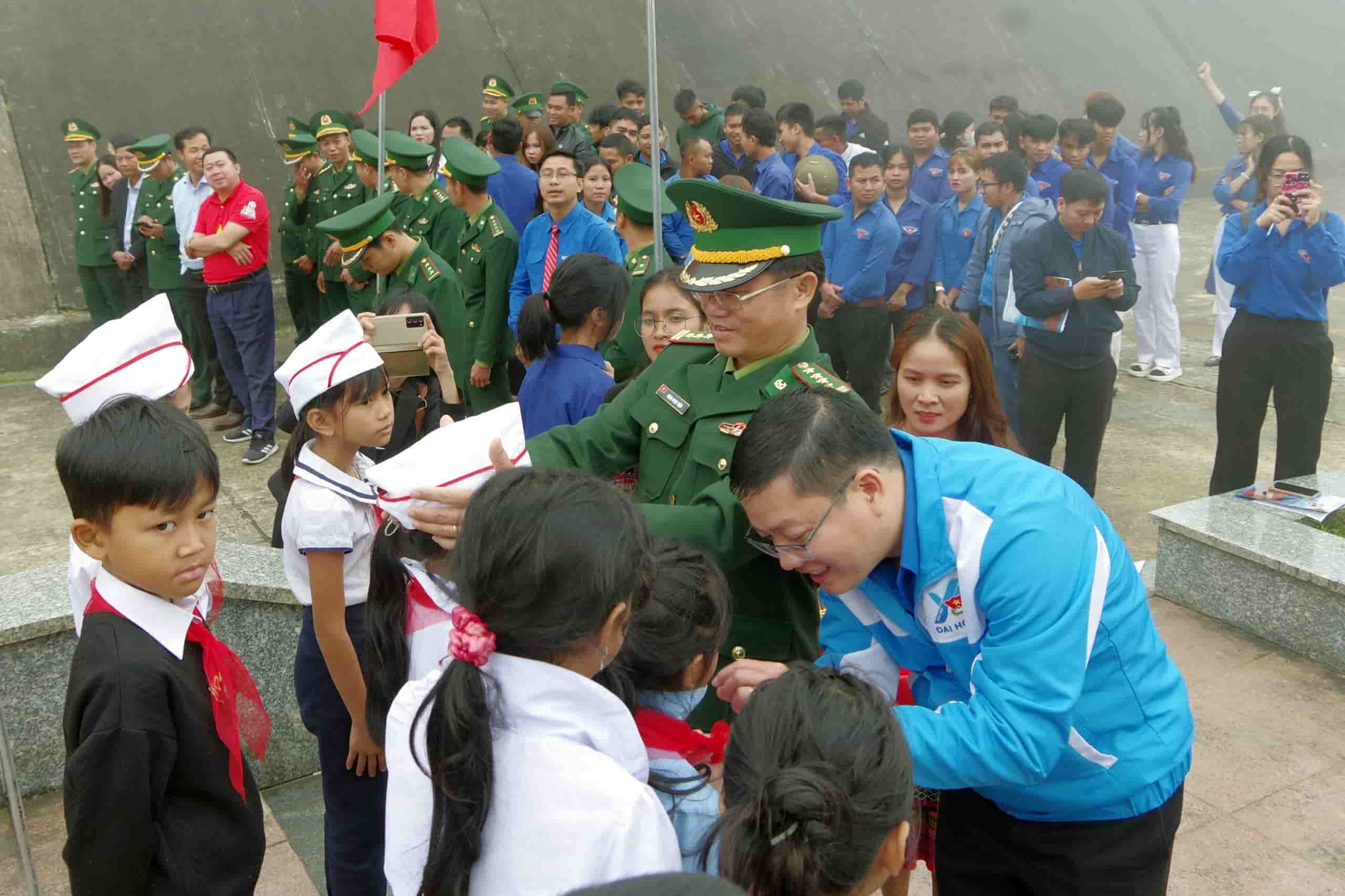 Đại diện Tỉnh đoàn và Bộ chỉ huy BĐBP tỉnh đeo khăn quàng đỏ cho đội viên ở biên giới. Ảnh: Võ Tiến.