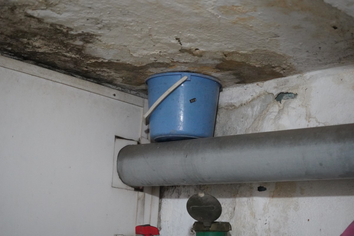 Bên trong căn hộ, nước từ toilet nhà dân bên trên thấm dột xuống căn hộ bên dưới, người dân phải dùng xô để hứng nước.