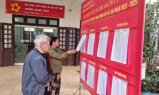 Người dân xem danh sách cử tri được niêm yết tại UBND phường Quang Trung - một trong các đơn vị thuộc diện điều chỉnh địa giới hành chính của thị xã Sơn Tây (Hà Nội). Ảnh: Ánh Dương