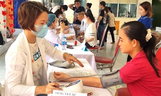 Bác sĩ của Công ty cổ phần Bệnh viện Y dược Sài Gòn đo huyết áp cho đoàn viên, người lao động. Ảnh: Nam Dương