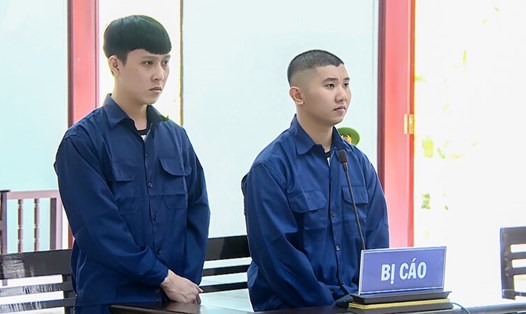 Bị cáo Bùi Thanh Tư (trái) và Phạm Vĩ An (phải)  tại tòa . Ảnh: Công an cung cấp. 