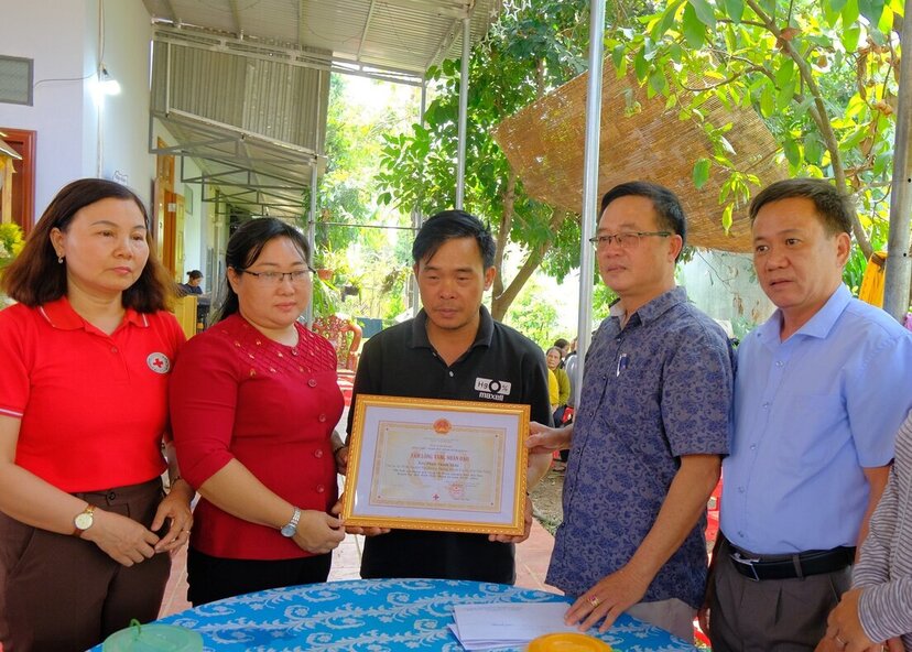 Hội Chữ thập đỏ tỉnh Đắk Nông trao tặng bàng ghi nhận “Tấm lòng vàng nhân đạo” cho đại diện gia đình em Pham Thanh Xuân. Ảnh: Bảo Lâm