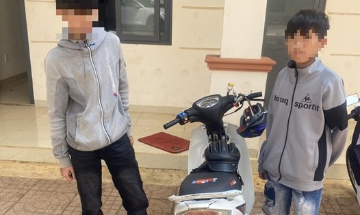 Hai thiếu niên lái xe máy, không đội mũ bảo hiểm cầm theo súng nhựa chạy trên đường. Ảnh: Cao Nguyên