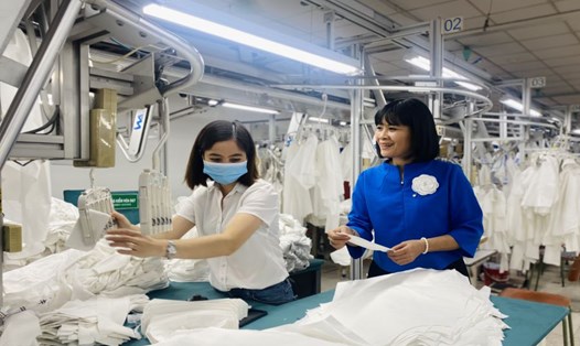 Bà Đỗ Hồng Vân thăm nữ công nhân tại dây chuyền sản xuất của Công ty May 10. Ảnh: Nhân vật cung cấp
