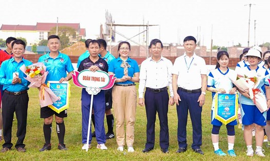 Lãnh đạo Liên đoàn Lao động tỉnh, UBND huyện trao cờ lưu niệm và hoa cho các đội thi đấu. Ảnh: Duy Chương.
