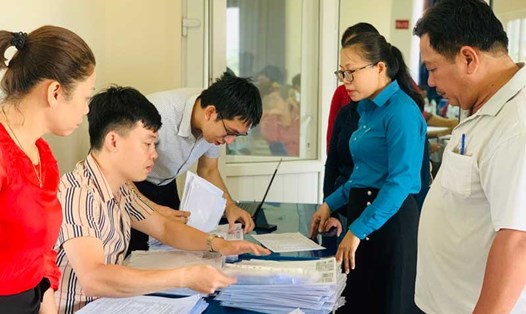Bà Lê Thị Ngọc Oanh (áo xanh), Phó Chủ tịch Công đoàn Khu hỗ trợ người lao động làm hồ sơ khởi kiện doanh nghiệp. Ảnh: Tường Minh