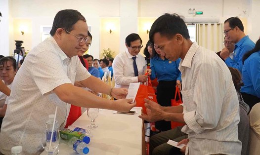 Phó Bí thư Tỉnh ủy Đồng Nai Quản Minh Cường (góc trái) trao quà cho người lao động. Ảnh: Hà Anh Chiến