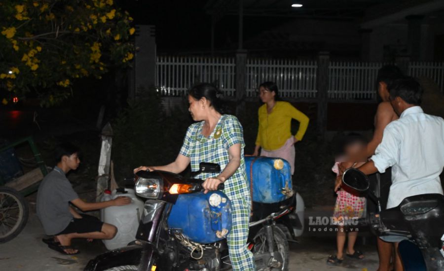 Người dân ở xã Tân Điền (huyện Gò Công Đông, tỉnh Tiền Giang) đem can đến vòi nước công cộng lấy nước vào ban đêm. Ảnh: Thành Nhân