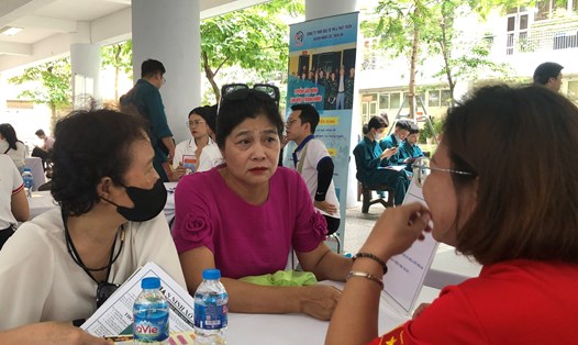 Bà Trần Hoàng Lan (giữa) tìm kiếm công việc tại Phiên giao dịch việc làm lưu động quận Ba Đình năm 2024. Ảnh: Thục Quyên 