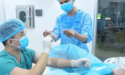 Các bác sĩ IVFTA đang thực hiện chuyển phôi cho người bệnh. Ảnh: PHONG LAN