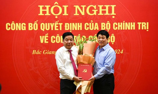 Thường trực Ban Bí thư Trung ương Đảng Lương Cường (bên phải ảnh) trao quyết định và tặng hoa chúc mừng Trung tướng Nguyễn Văn Gấu. Ảnh: Vân Trường
