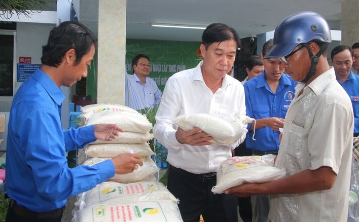 Giám đốc Sở Tài nguyên Môi trường tỉnh Bạc  Liêu Nguyễn Bình Thuận trao gạo cho người dân phường 3 trong chương trình đôi chay nhựa lấy gạo. Ảnh: Nhật Hồ