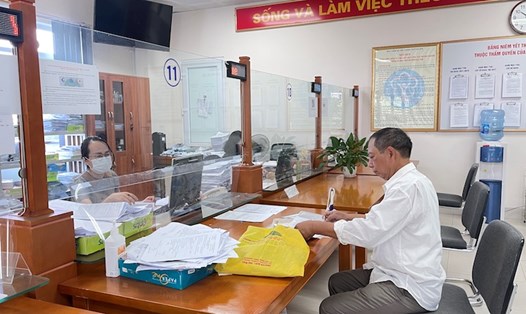 Cán bộ BHXH Việt Nam tư vấn cho người lao động về chính sách BH thất nghiệp. Ảnh: Hà Anh