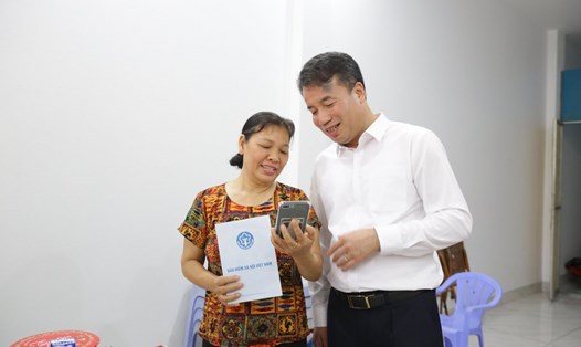 Người dân chia sẻ niềm vui khi được nhận lương hưu mới tăng với Tổng Giám đốc BHXH Việt Nam Nguyễn Thế Mạnh. Ảnh chụp chiều 1.7: BHXH Việt Nam 