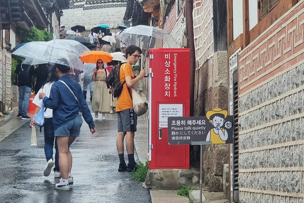 Signs ask visitors to speak quietly in residential areas. Photo: CNN