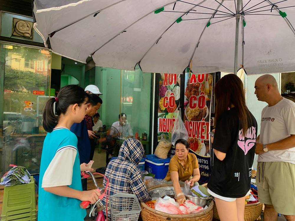 Ms. Nguyet's 25-year-old traditional sticky rice shop has long lines every day. Photo: Hong Tu