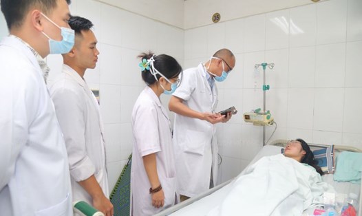 PGS.TS Nguyễn Hồng Hà, Trưởng khoa Phẫu thuật Tạo hình Thẩm mỹ, Bệnh viện Hữu nghị Việt Đức kiểm tra sức khỏe người bệnh. Ảnh: Bích Ngọc