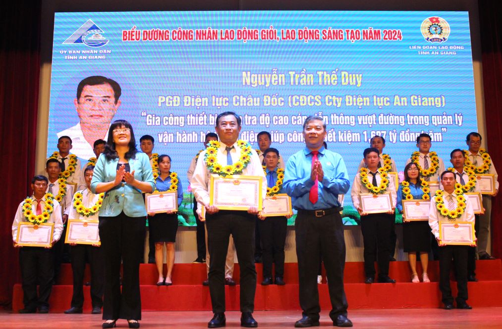 Vice Chairman of the Confederation of Labor of An Giang province Nguyen Huu Giang (right) awards union members and workers with the title "Good worker, creative worker". Photo: Lam Dien