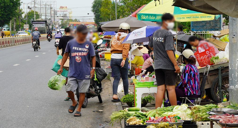 Sidewalks are occupied to display all kinds of food, buyers and sellers carefreely regardless of traffic safety.