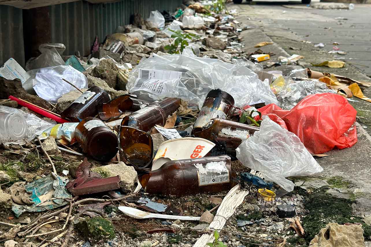 Garbage is flooded from inside to outside the lot.