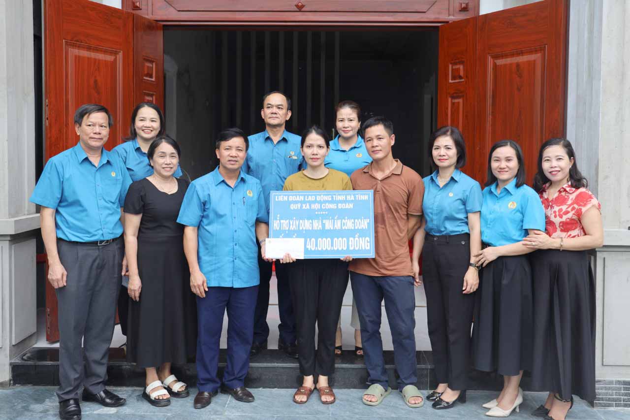 Ông Nguyễn Văn Danh - Chủ tịch LĐLĐ tỉnh Hà Tĩnh trao tiền hỗ trợ làm nhà "Mái ấm công đoàn". Ảnh: Xuân Truyền.