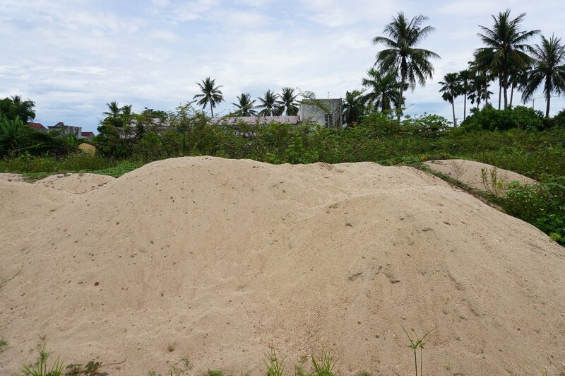 Authorities arrested smugglers and overloaded sand trucks, then confiscated this sand and dumped it into Son Tinh stadium. Photo: Vien Nguyen