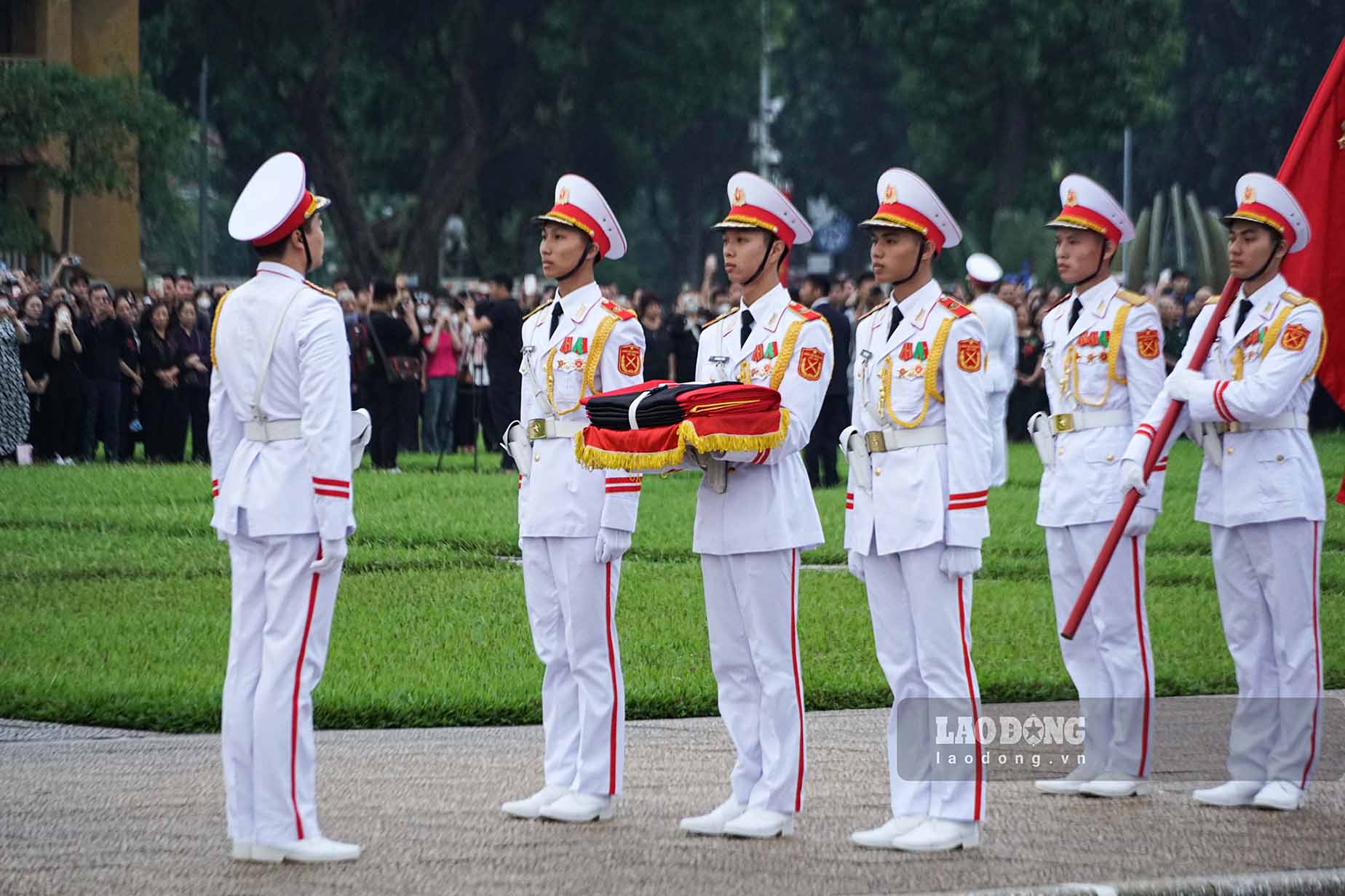 At the head of the group is the military flag "Determined Victory".