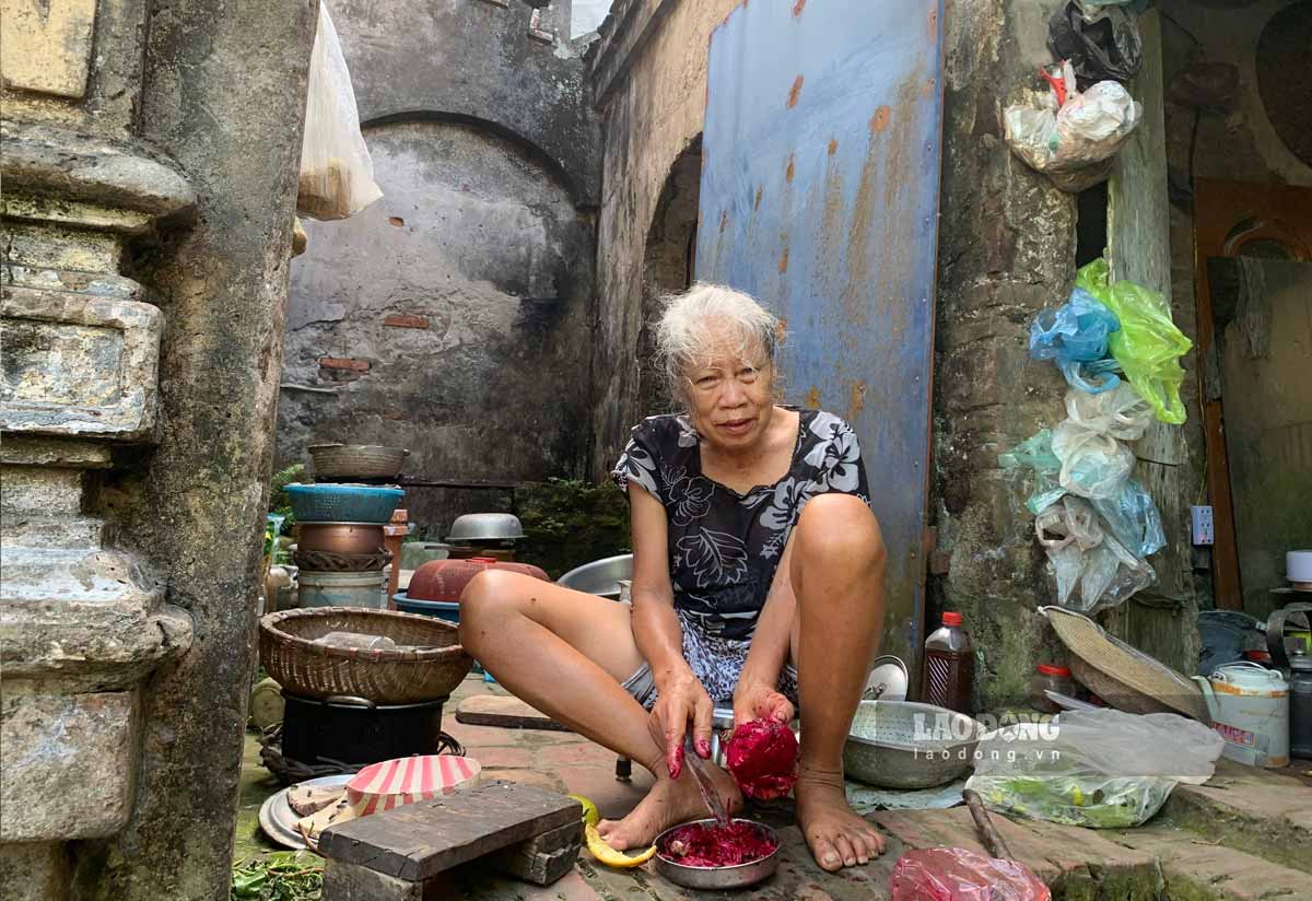 Mrs. Hong cut pieces of damaged dragon fruit to use to raise chickens. Photo: Ha Vi