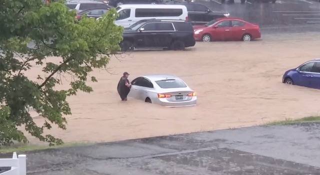 Cars trying to move on a flooded road in Dollywood Park in Pigeon Forge, Tennessee, USA on July 28. Screenshot