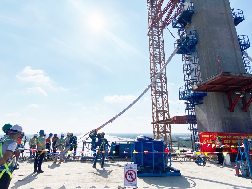 Workers perform the first cable tensioning.