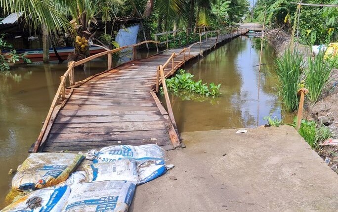 Nguyên đoạn đường giao thông sụt lún xuống, tại huyện Hồng Dân, chính quyền địa phương khắc phục bằng cách bắt cầu ván tạm cho xe  qua lại. Ảnh: Nhật Hồ