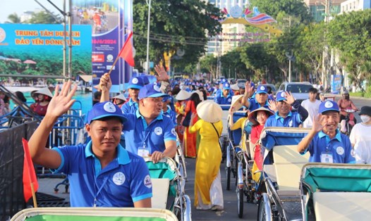 Đoàn viên Nghiệp đoàn Xích lô Du lịch Nha Trang với bộ áo xanh nhận diện Công đoàn tham gia diễu hành áo dài trên đường phố Nha Trang. Ảnh: Phương Linh