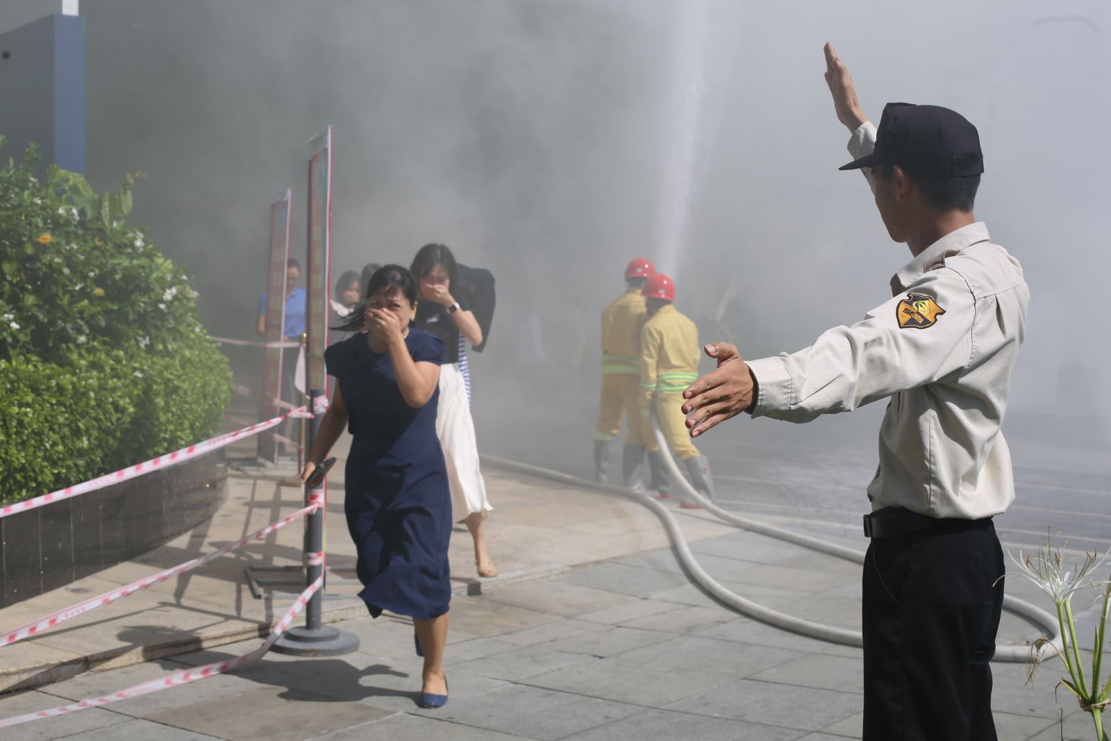 Nhân viên khách sạn hướng dẫn thoát hiểm cho người bên trong tòa nhà. Ảnh: Văn Trực