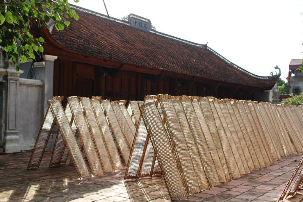 Rice paper rolls are dried by people in the yard of Tho Ha pagoda. Photo: Thach Luu