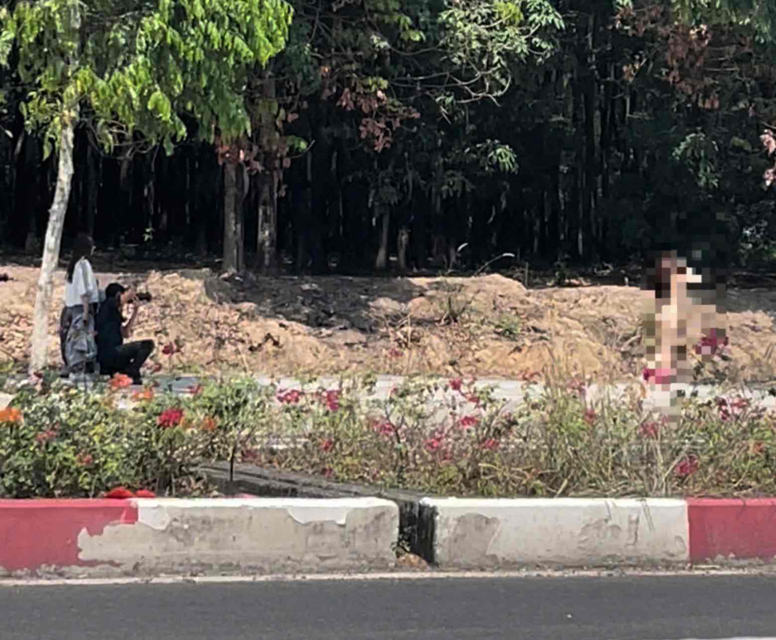 A group of people calmly took nude photos on a busy street. Photo cut from clip provided by people