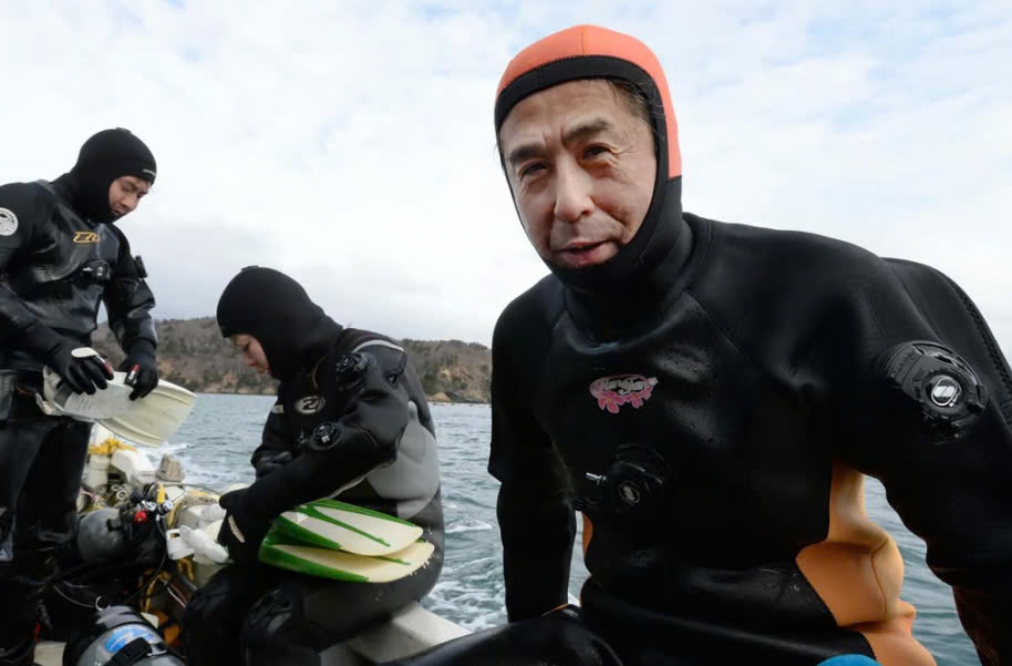 The husband learned to dive to search for his wife's body, missing after the 2011 disaster in Japan. Photo: AFP