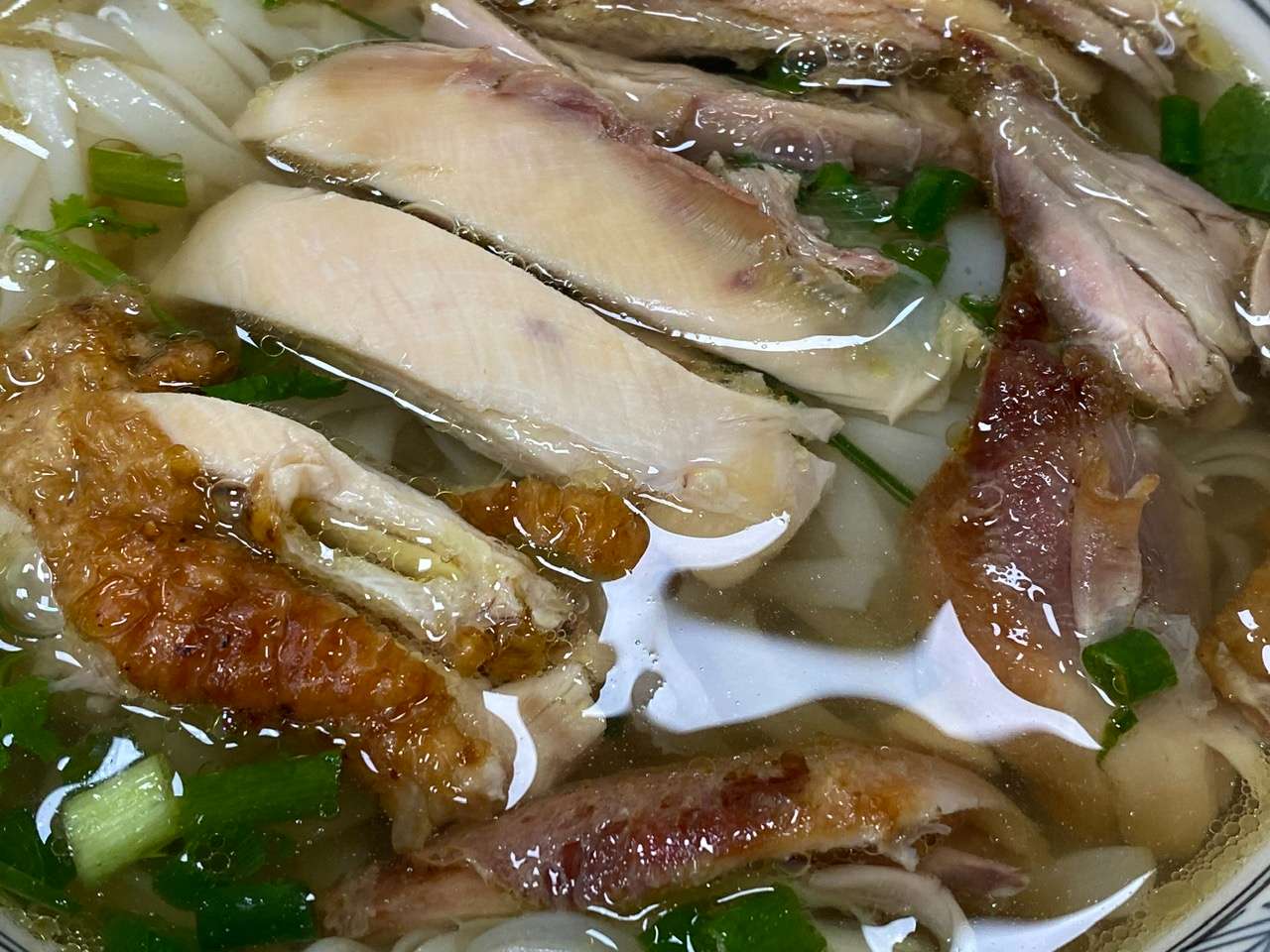 The noodles are soft and chewy, the grilled chicken is golden and crispy, and the broth is rich with chicken fat flavor. Photo: Minh Thuong