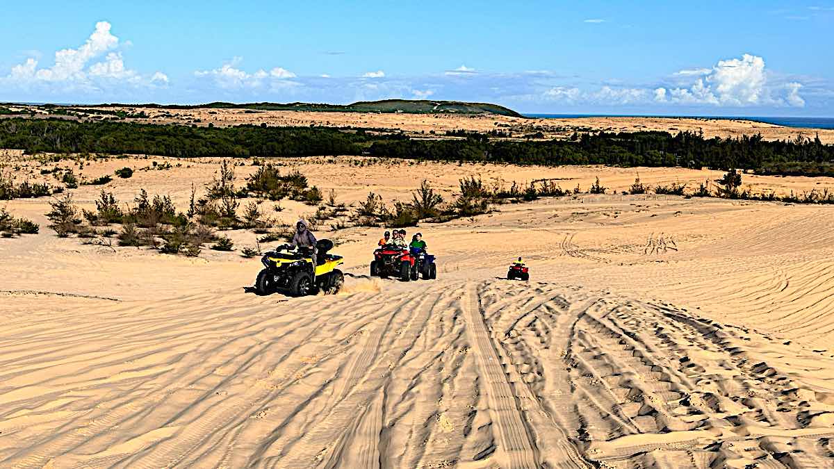 ATV terrain vehicles carry tourists up sand dunes. Photo: Duy Tuan