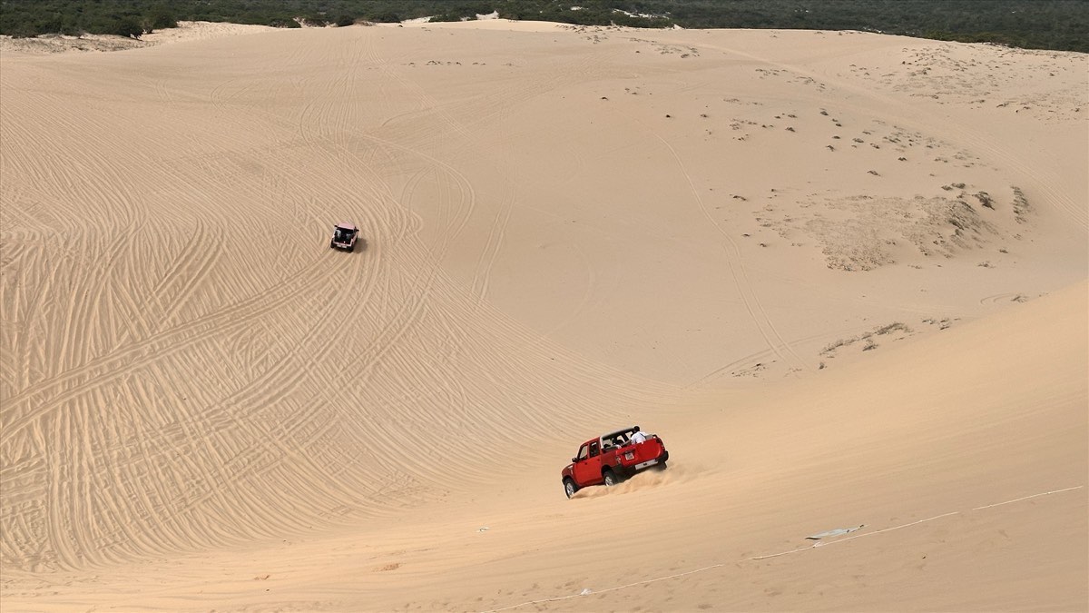 All-terrain vehicles carry passengers down the sand dunes. Photo: Duy Tuan