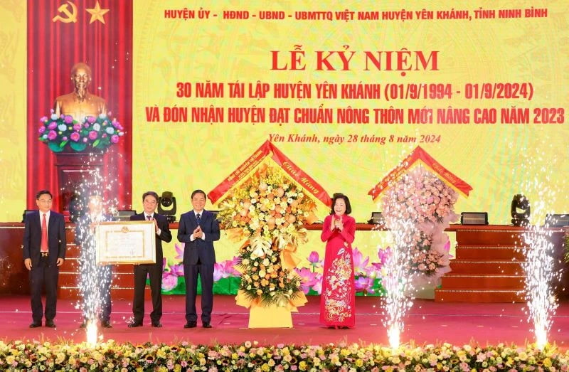 Phó Chủ tịch Quốc hội Nguyễn Thị Thanh trao Bằng công nhận Huyện đạt chuẩn nông thôn mới nâng cao và tặng hoa chúc mừng Đảng bộ, chính quyền và nhân dân huyện Yên Khánh. Ảnh: Nguyễn Trường