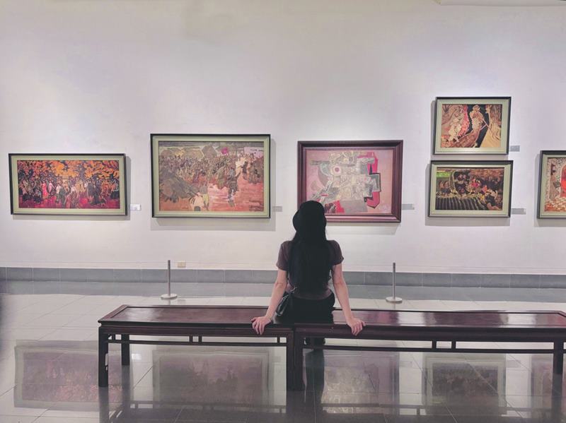 Female tourists take pictures at the Vietnam Fine Arts Museum.