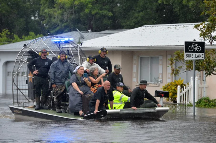 Residents evacuate by boat due to flooding caused by Tropical Storm Debby. Image: USA TODAY Network