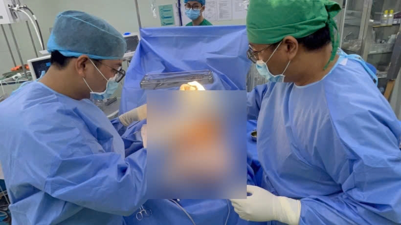 The surgical team performs surgery