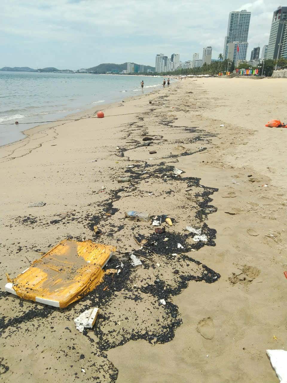 Oil clumps washed ashore in Nha Trang. Photo: Nha Trang Bay Management Board