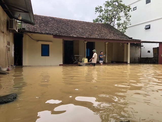 A resident's house is near the dike, but the entire yard was flooded.